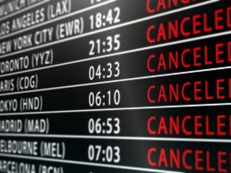 Airport departure board showing international flights cancelled